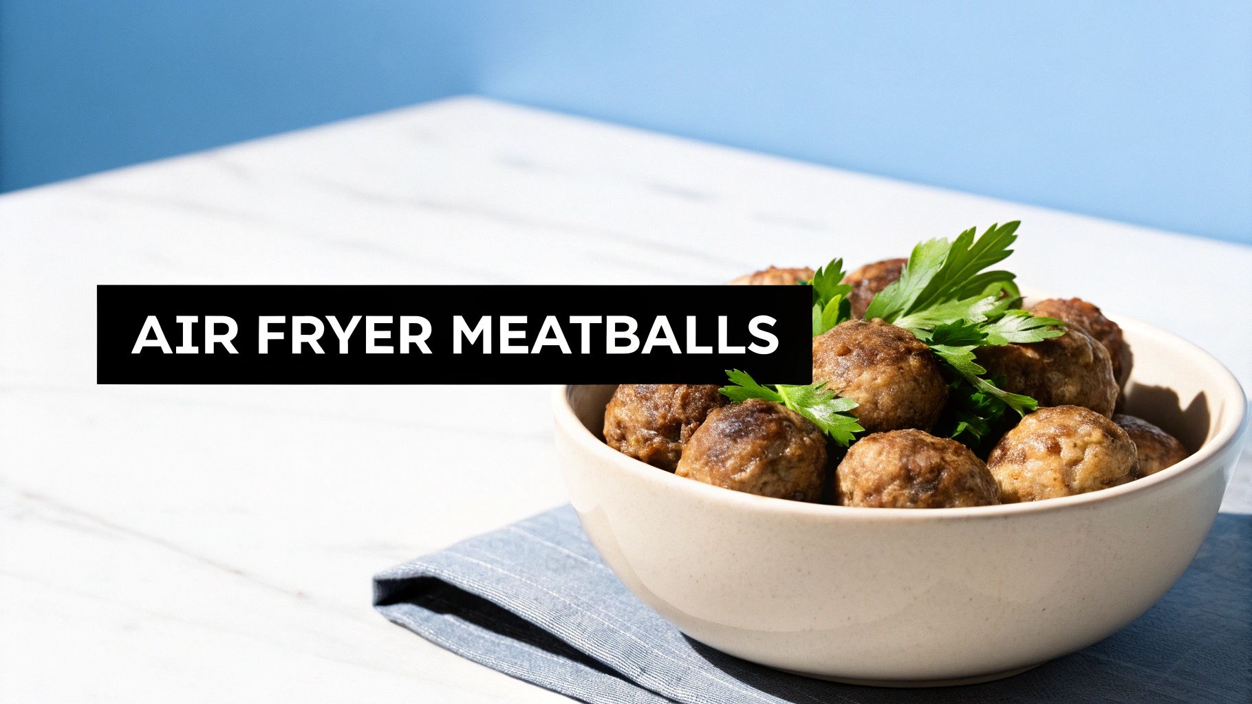 A close-up of a bowl of perfectly cooked air fryer meatballs, garnished with fresh parsley.