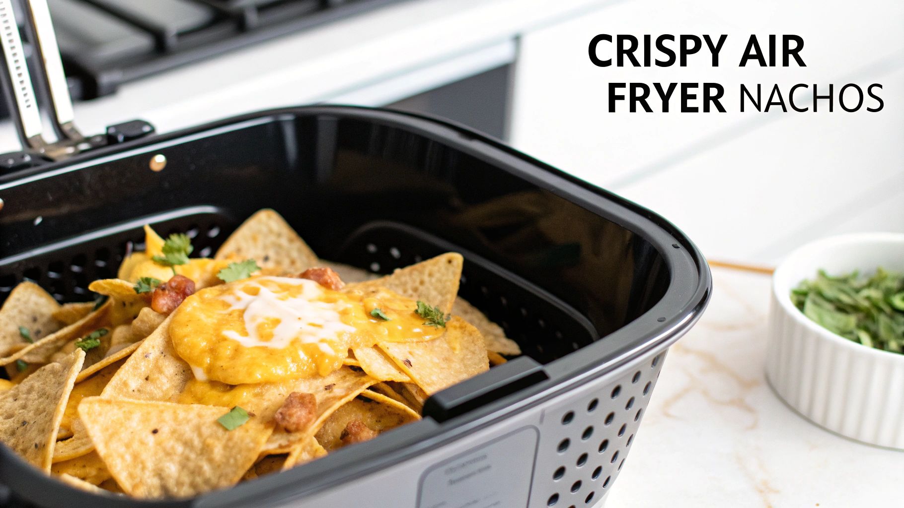 Delicious crispy air fryer nachos with melted cheese, meat, and fresh cilantro in a black basket.