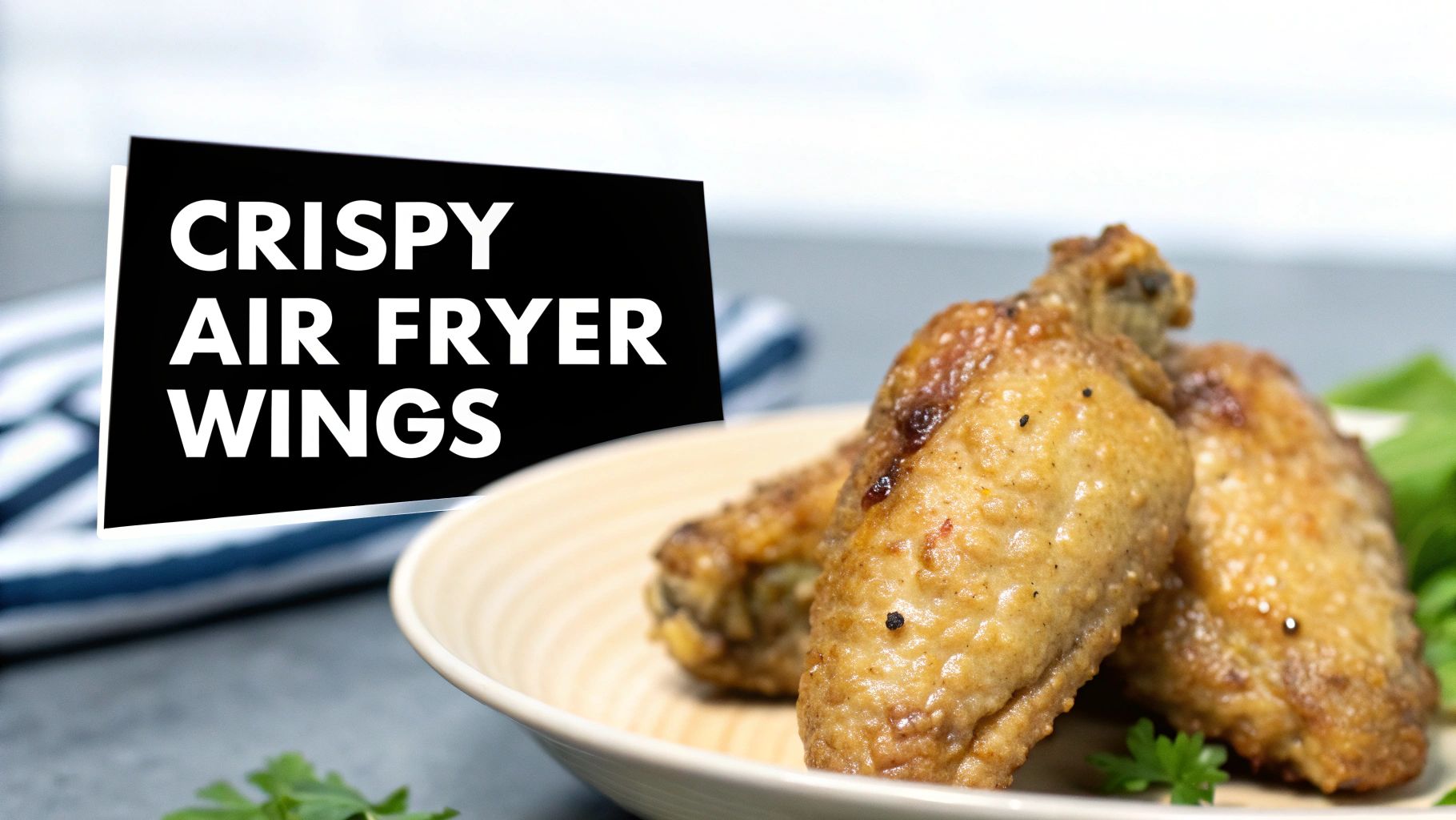 A close-up of crispy air fryer chicken wings on a white plate with fresh parsley garnish.