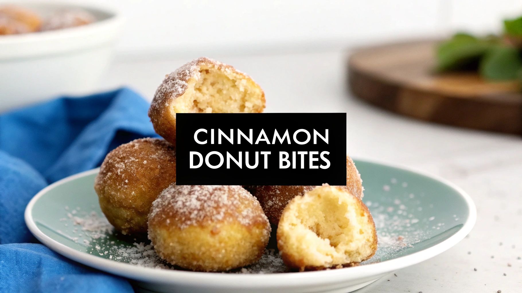 Delicious cinnamon donut bites on a blue plate, sprinkled with powdered sugar, ready to be enjoyed.