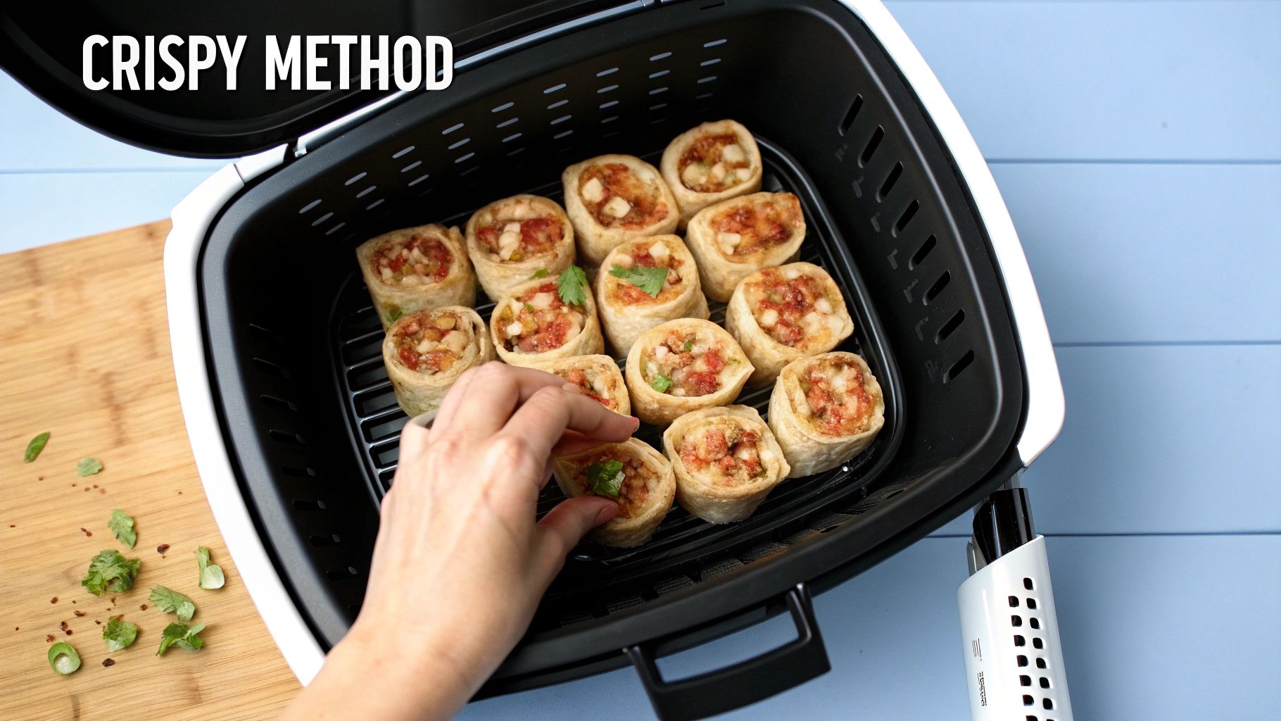 A hand places delicious pizza rolls into an air fryer basket, demonstrating a crispy cooking method.