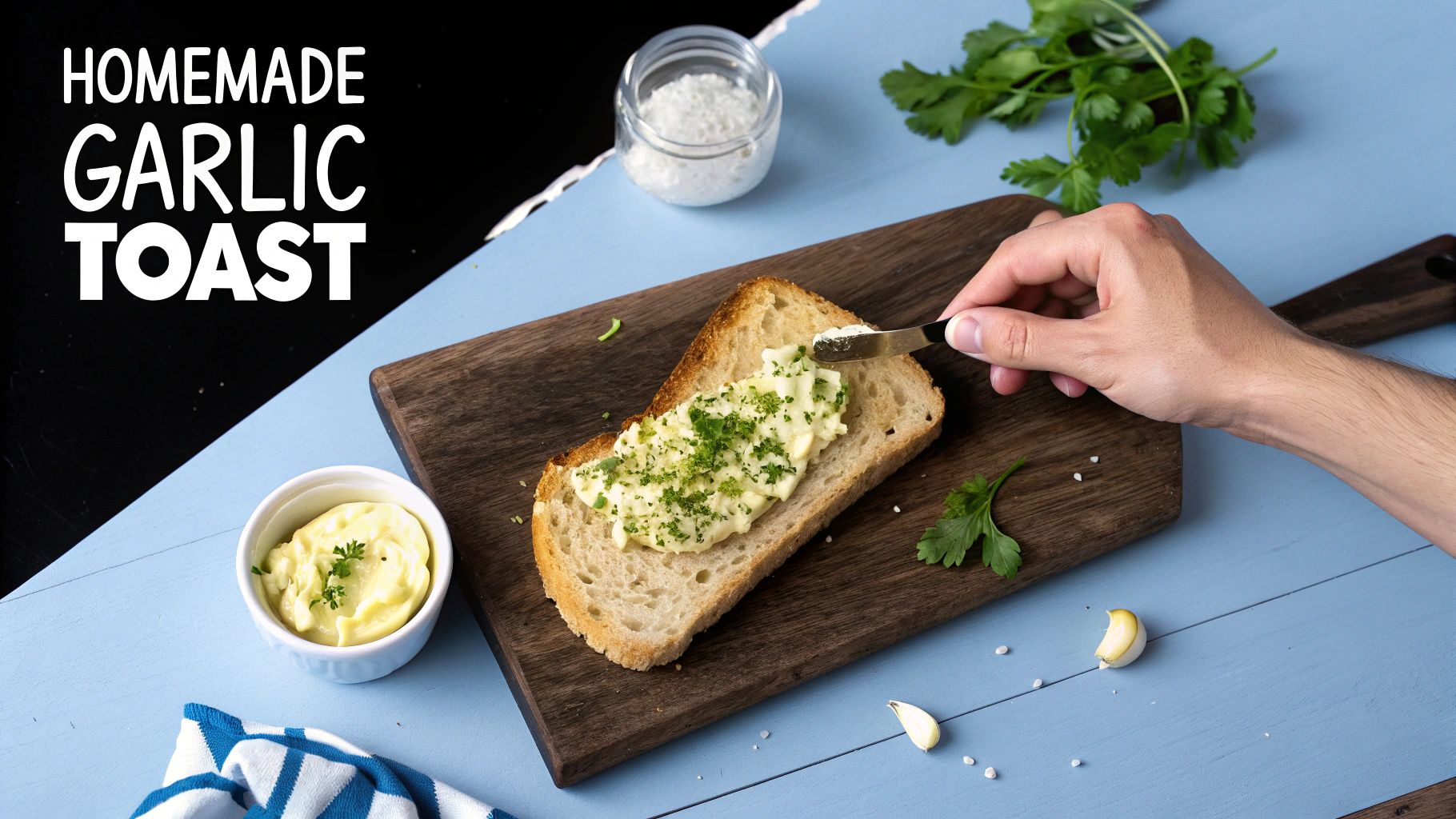 A hand spreads garlic butter on a slice of homemade toast, with fresh parsley and ingredients.