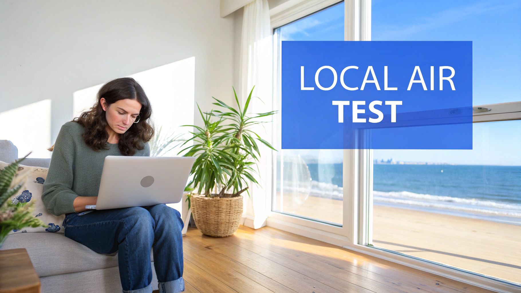 A woman works on a laptop indoors, overlooking a sunny beach and ocean view with a 'LOCAL AIR TEST' graphic.