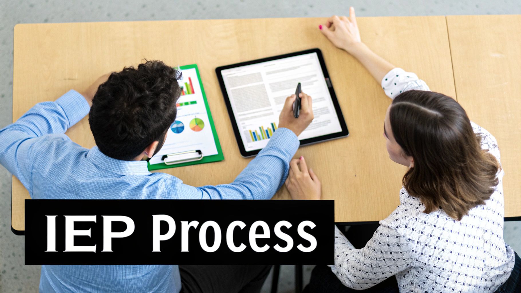 Two people collaboratively reviewing special education IEP documents and data on a tablet and clipboard.