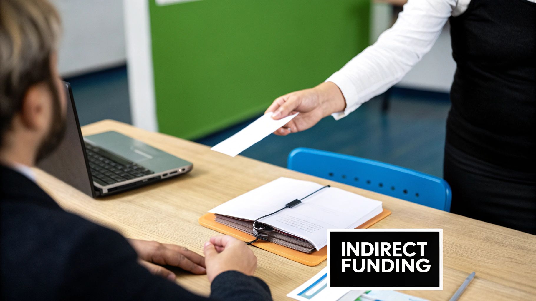 A person receives a document labeled 'Indirect Funding' from another person across a desk with a laptop.