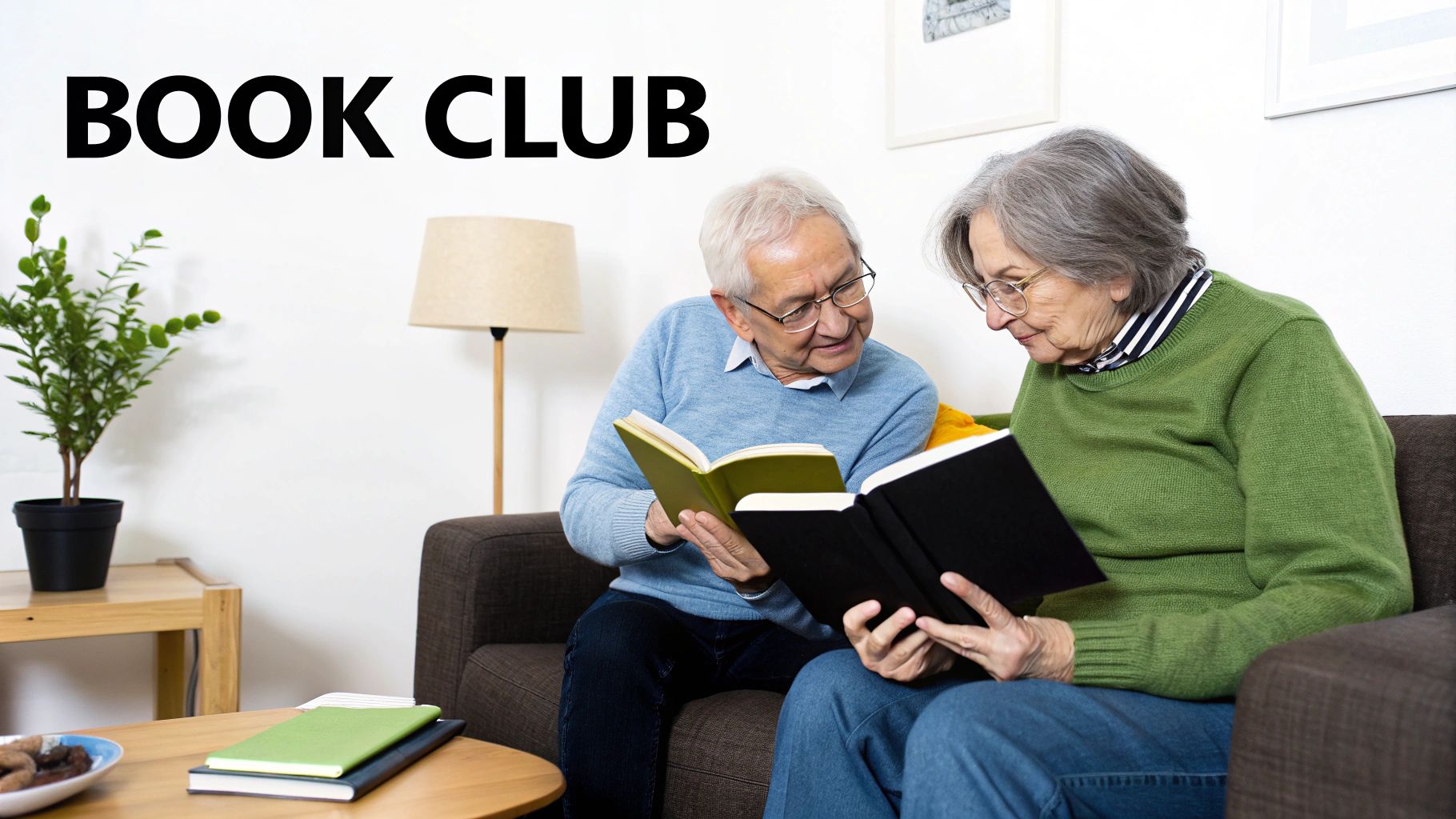 Two senior adults reading books together on couch at book club meeting