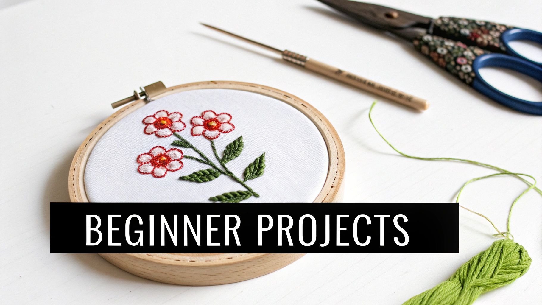 Embroidery hoop with floral design, punch needle, scissors, and green thread with 'BEGINNER PROJECTS' text.