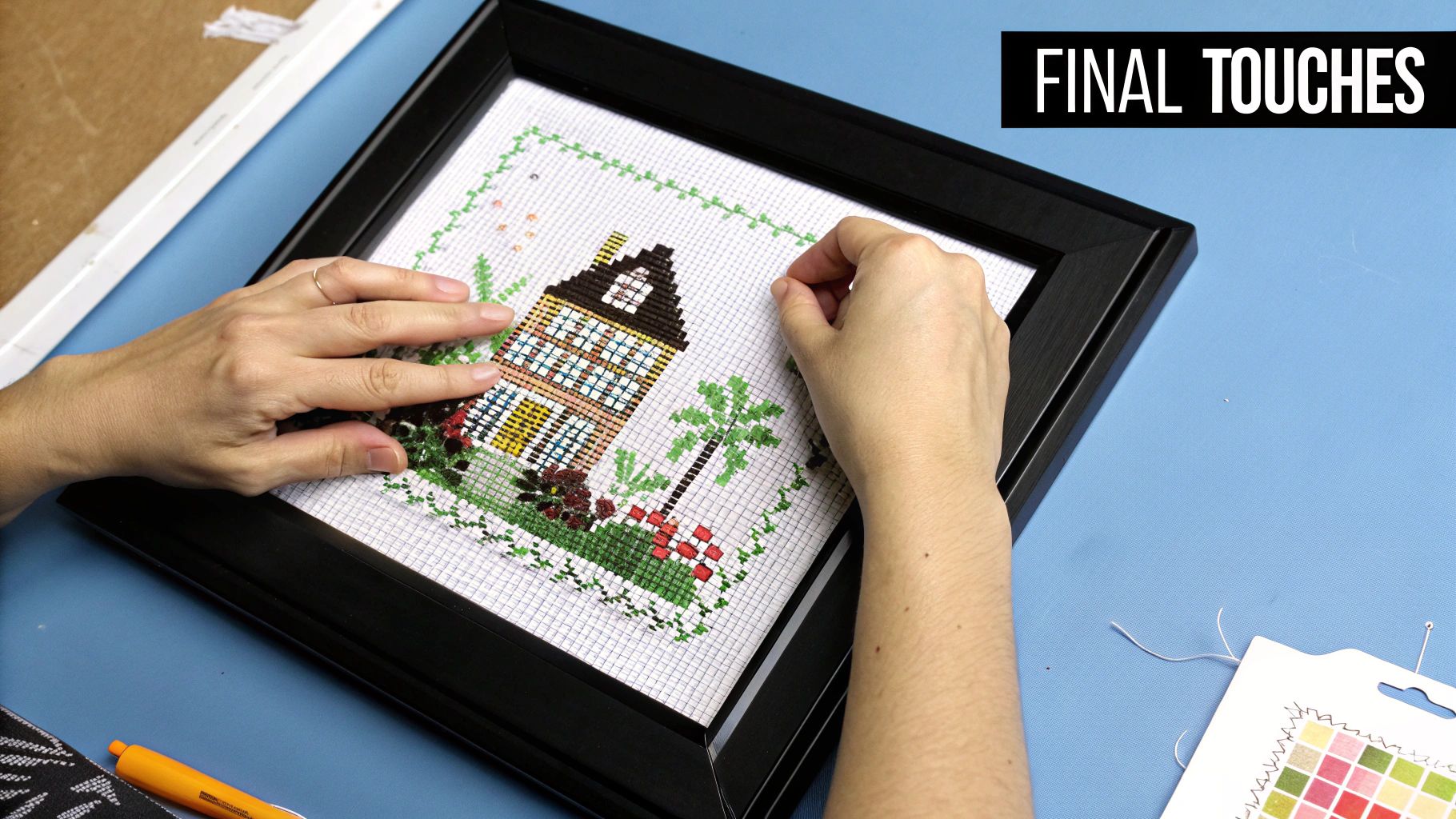 A beautifully framed cross stitch piece hanging on a wall