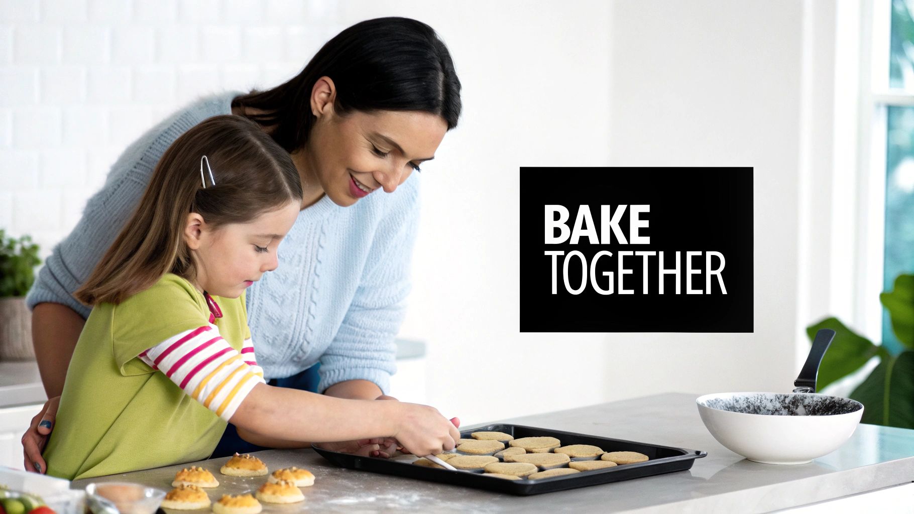 Mother and daughter baking cookies together in modern kitchen with inspirational sign on wall