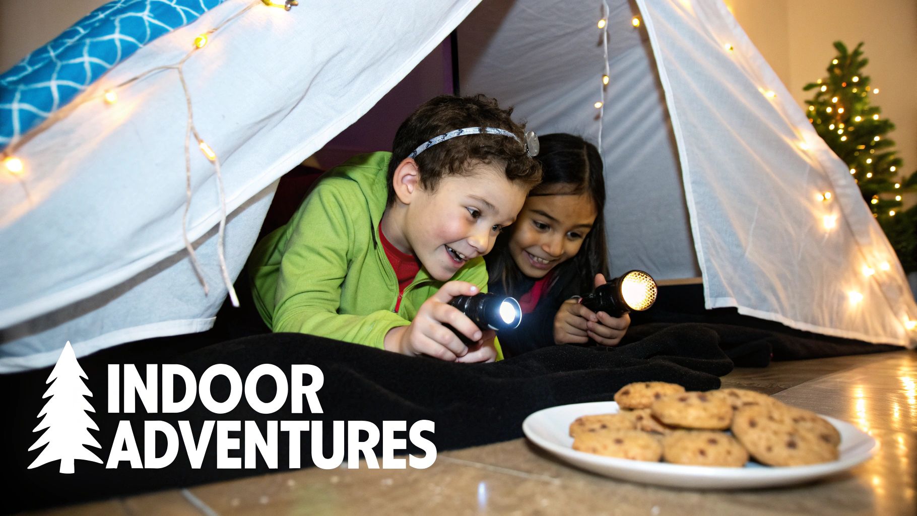 Two smiling children explore inside a cozy indoor tent with flashlights and string lights, enjoying cookies.