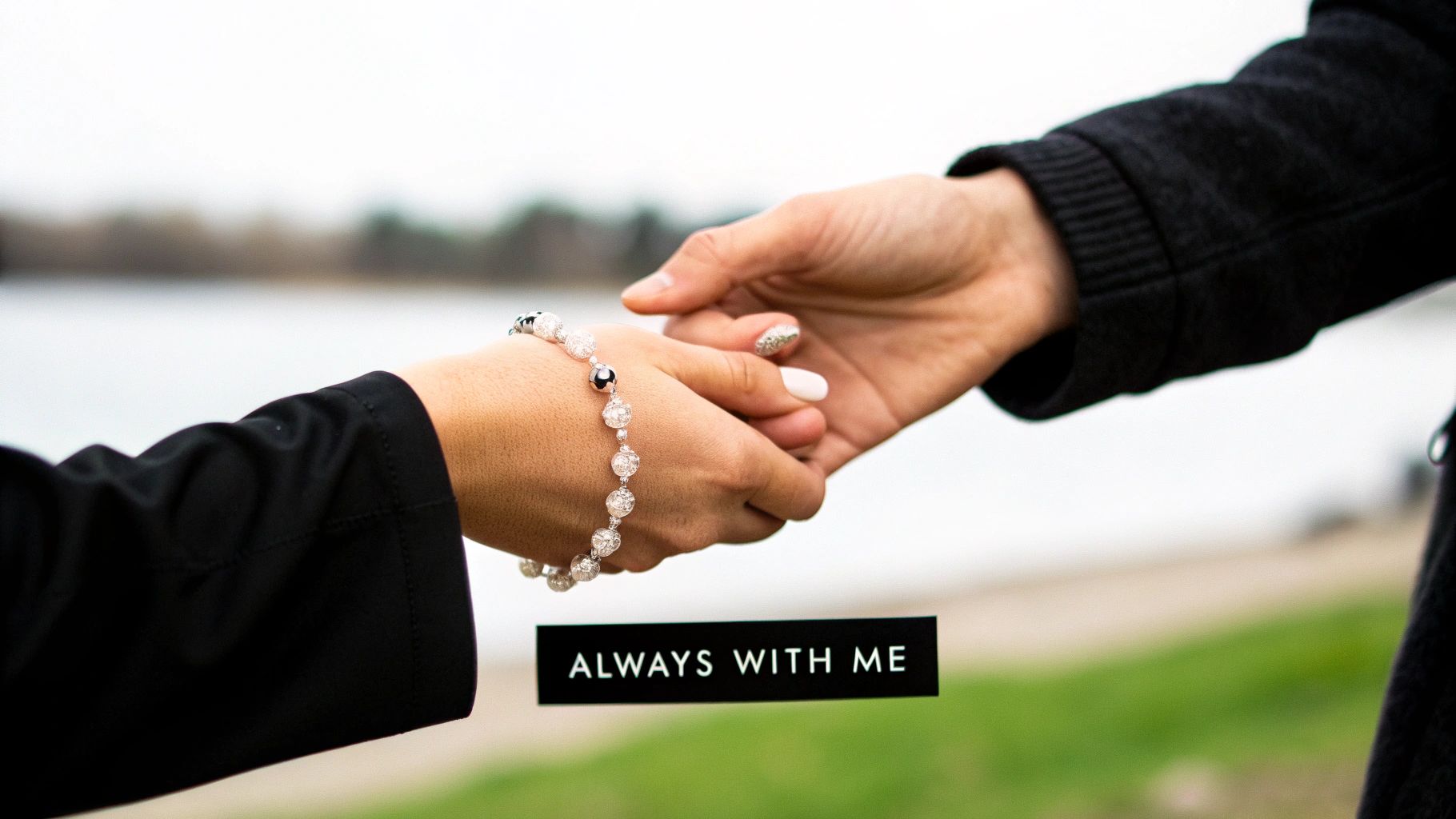 Two hands, one with a beaded memorial bracelet, holding each other with 'ALWAYS WITH ME' text.