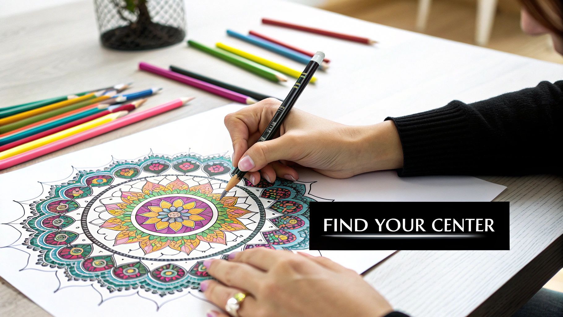 A person's hands coloring a vibrant mandala with colored pencils, engaging in mindful art.