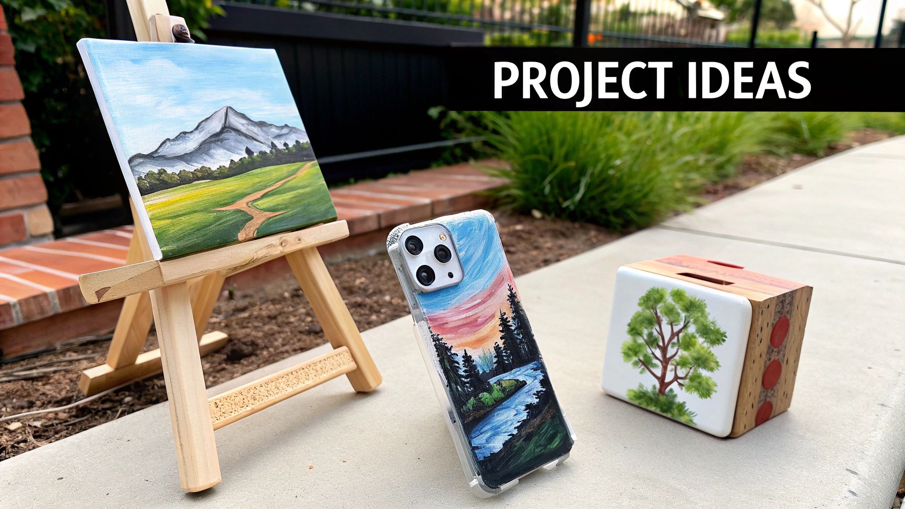 Three creative DIY art projects: a landscape painting on an easel, a painted phone case, and a wooden tree art.