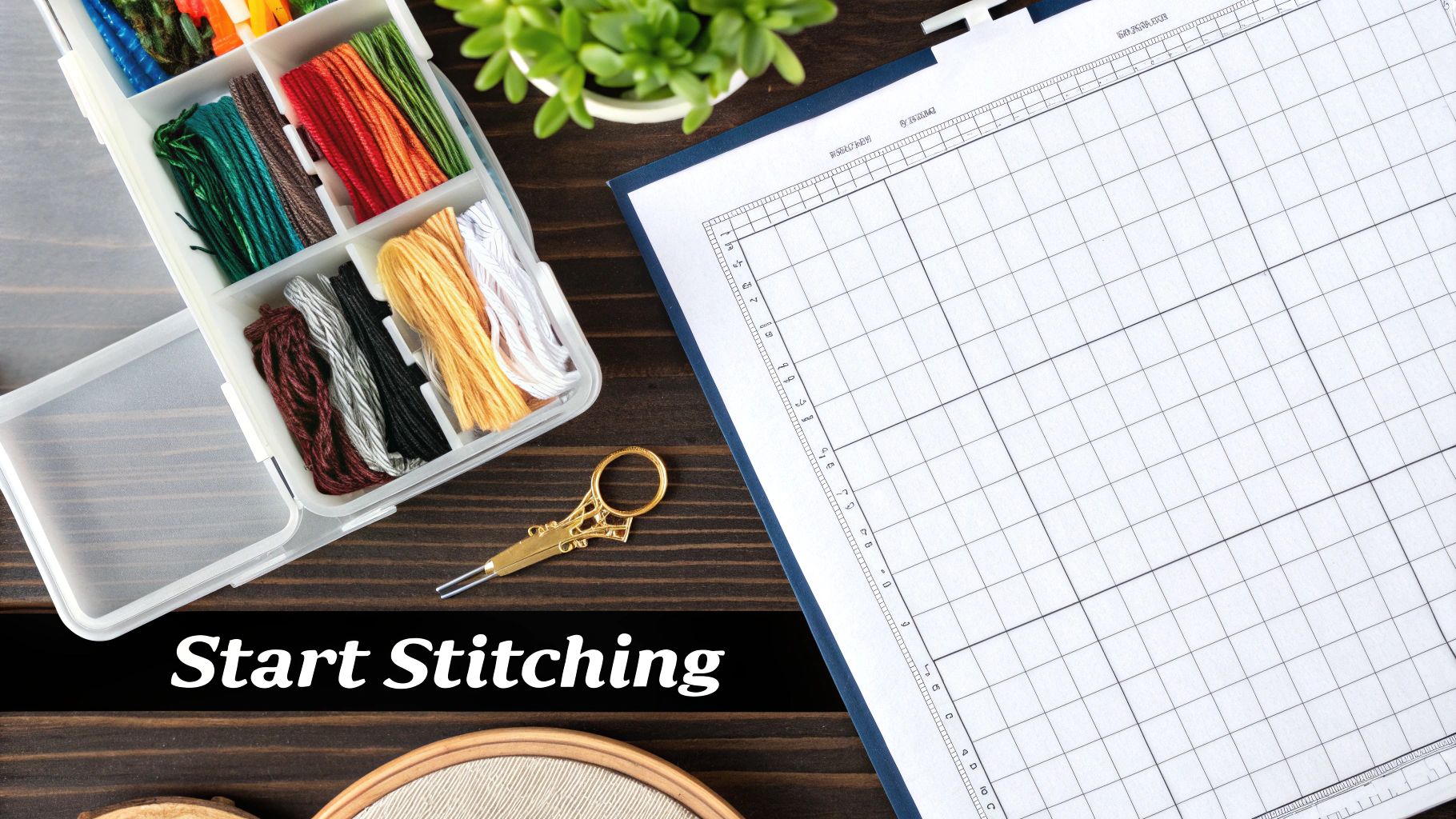 A flat lay of colorful embroidery floss, small scissors, a cross-stitch pattern, and an embroidery hoop.