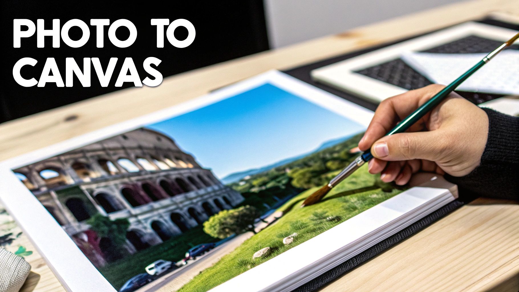 A hand holds a paintbrush over a print of the Colosseum and a landscape, with “PHOTO TO CANVAS” text.