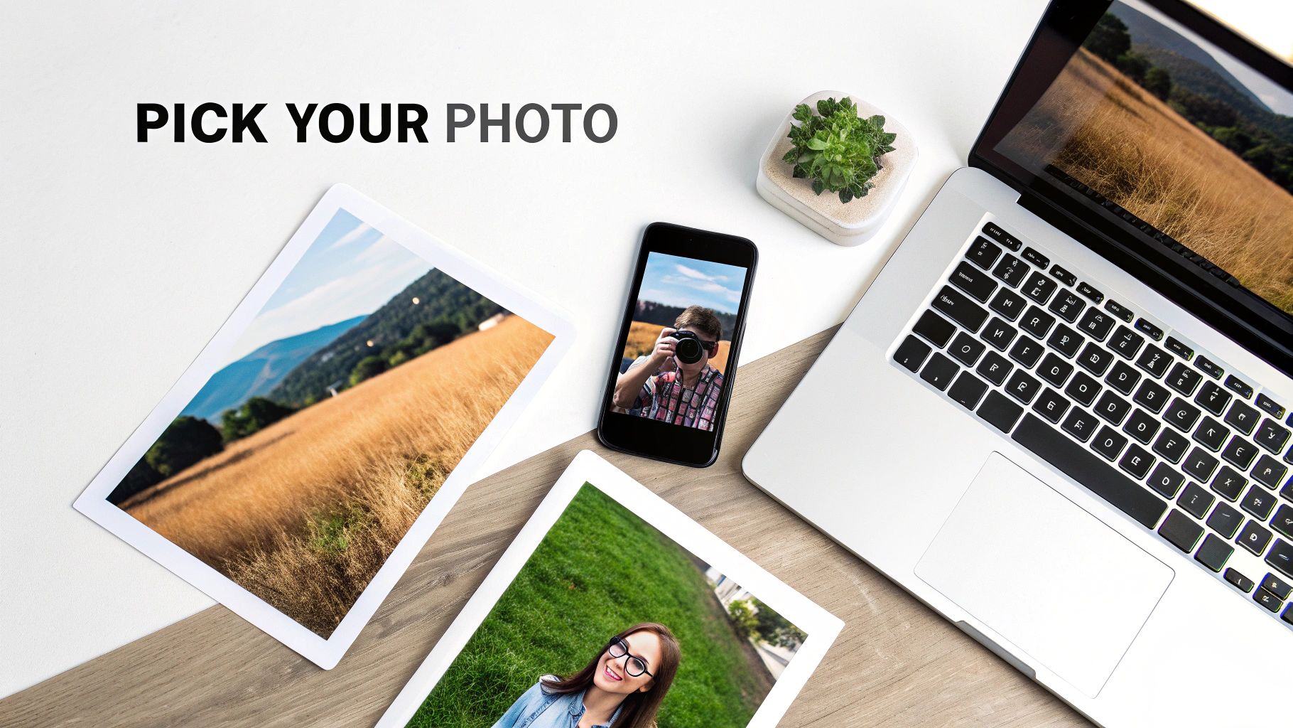 Flat lay of a desk with a laptop, smartphone, various photos, and a succulent, suggesting photo selection.