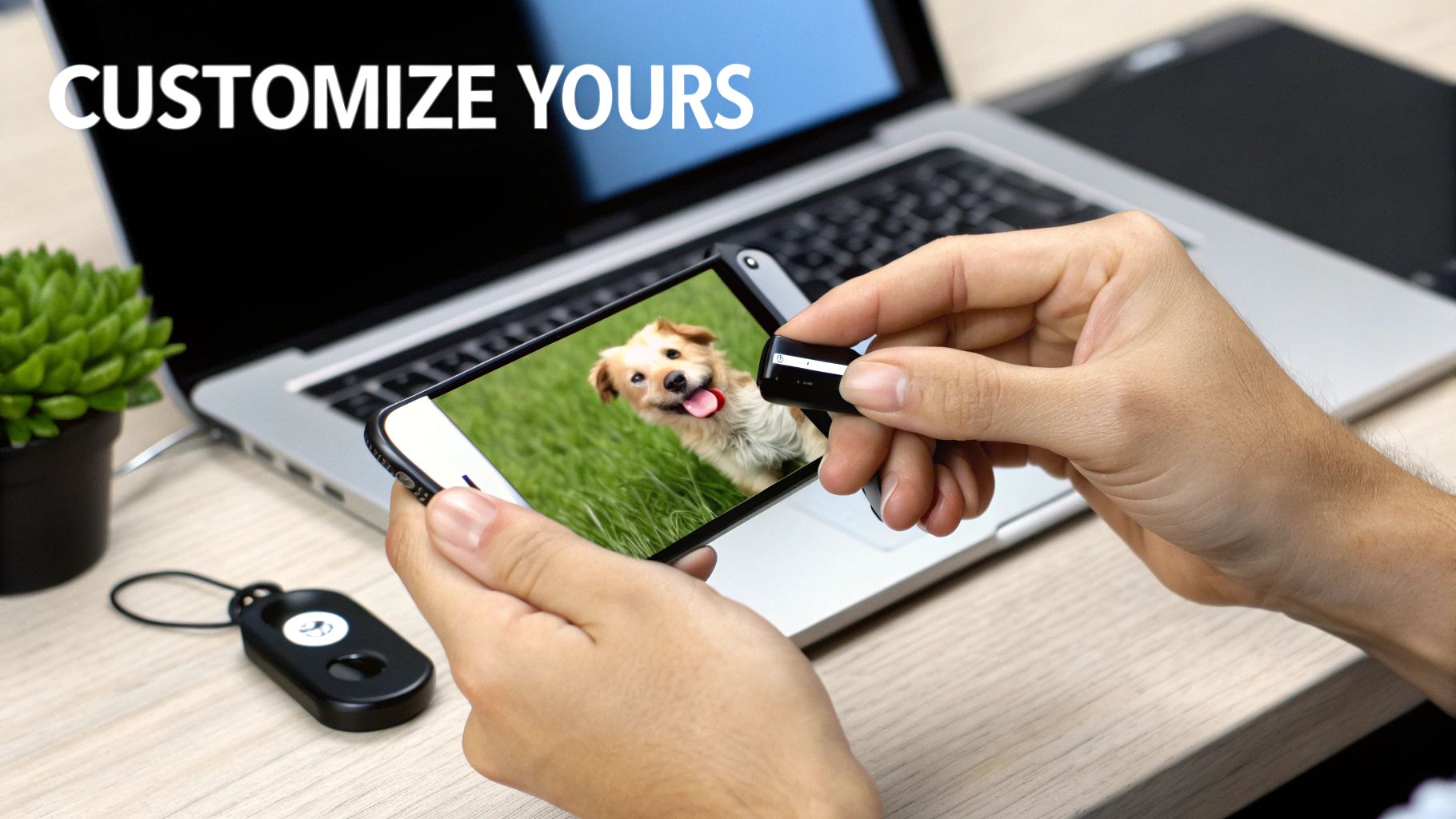 A person's hands holding a custom personalized pet necklace, with engraving tools in the blurred background.