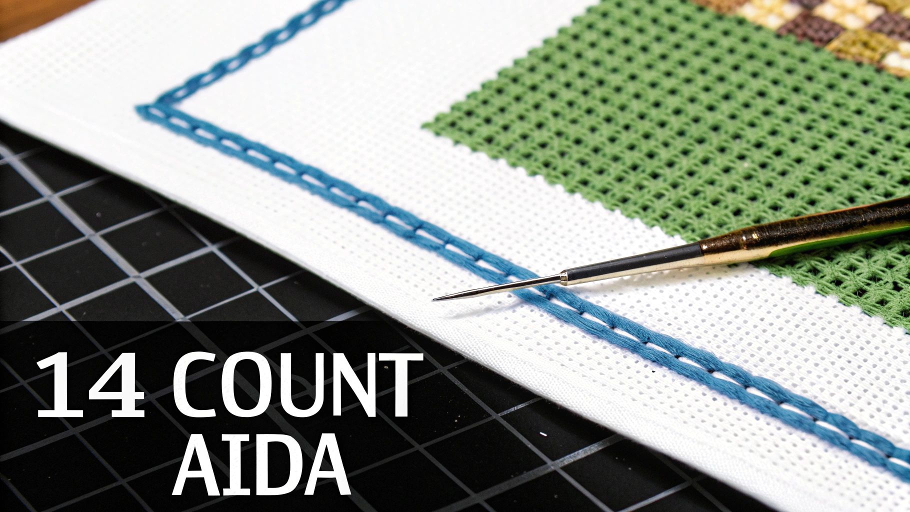 A close-up of 14 count Aida fabric showing its distinct grid pattern, ready for stitching.