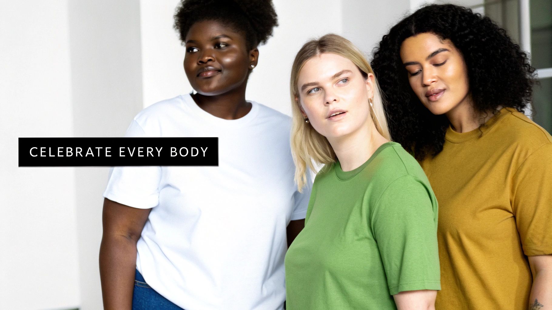 Three diverse women of various body types pose in plain t-shirts, promoting body positivity.