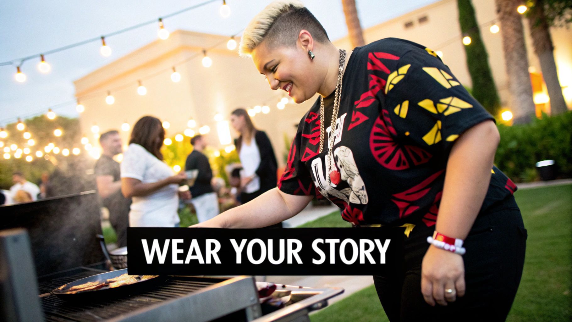 A person with blonde hair smiles while grilling food at an outdoor barbecue party.