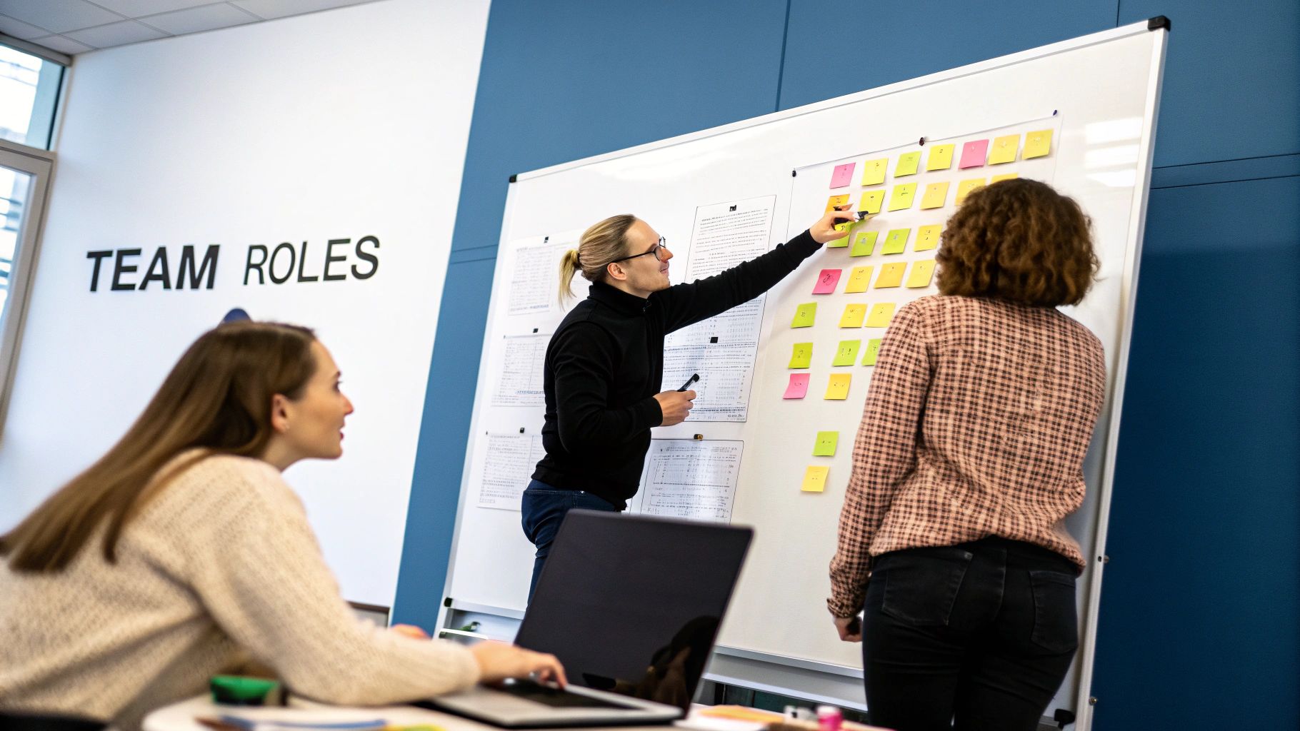 A team collaborating around a table with sticky notes, representing agile planning