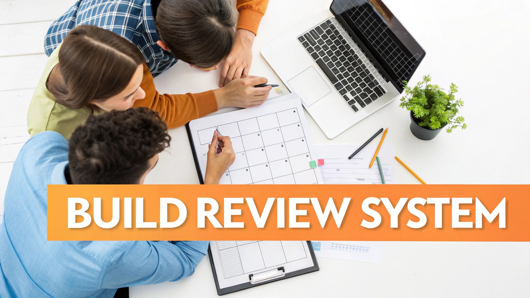 Three people collaborate around a table, planning a 'Build Review System' with a calendar and laptop.
