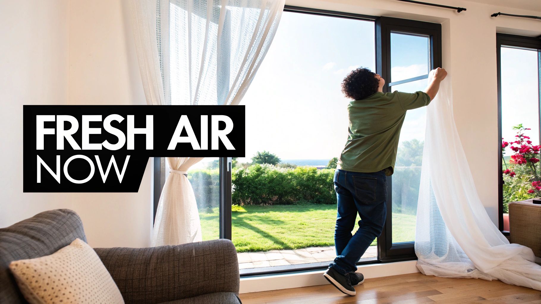A man opens a large window to a sunny garden and ocean view, letting fresh air into the house.