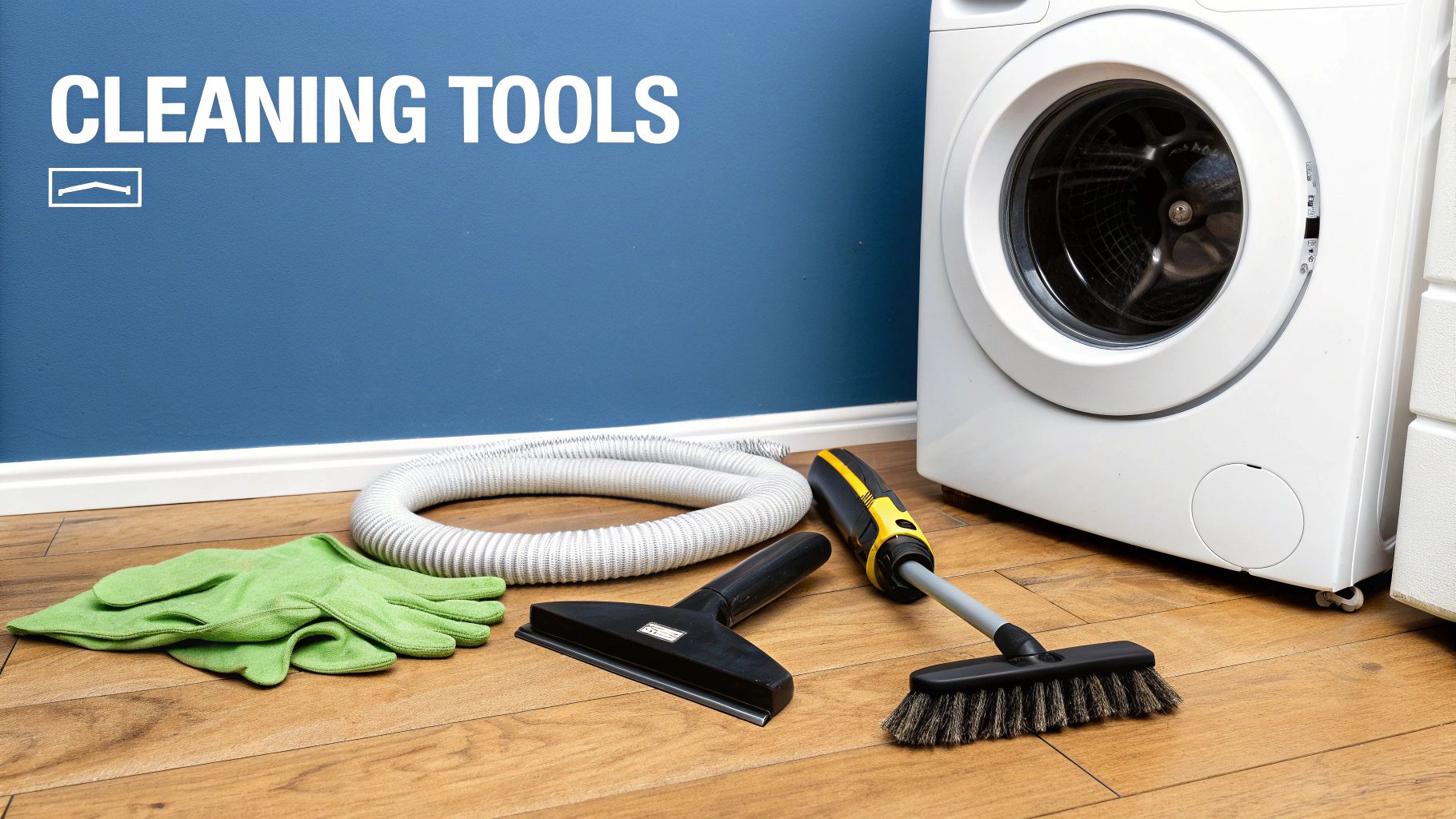 Green gloves, vacuum hose, squeegee, and floor brush beside a washing machine against a blue wall.